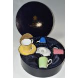 A BOXED ROYAL WORCESTER HARLEQUIN SET OF FOUR COFFEE CUPS AND SAUCERS, bears backstamp 'In