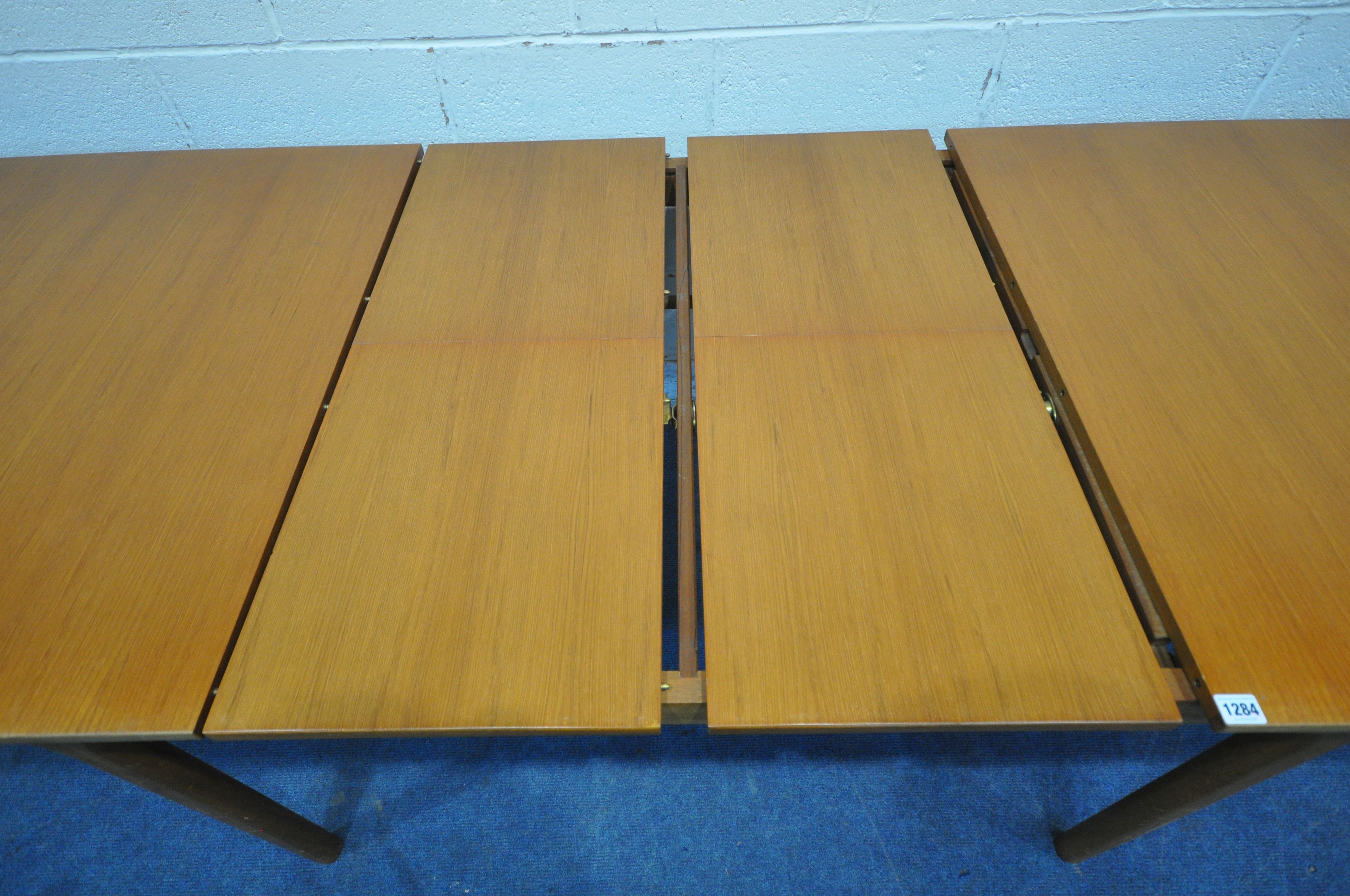 MCINTOSH OF KIRKCALDY, A MID CENTURY TEAK EXTENDING DINING TABLE, with two fold out leaves, raised - Image 7 of 10