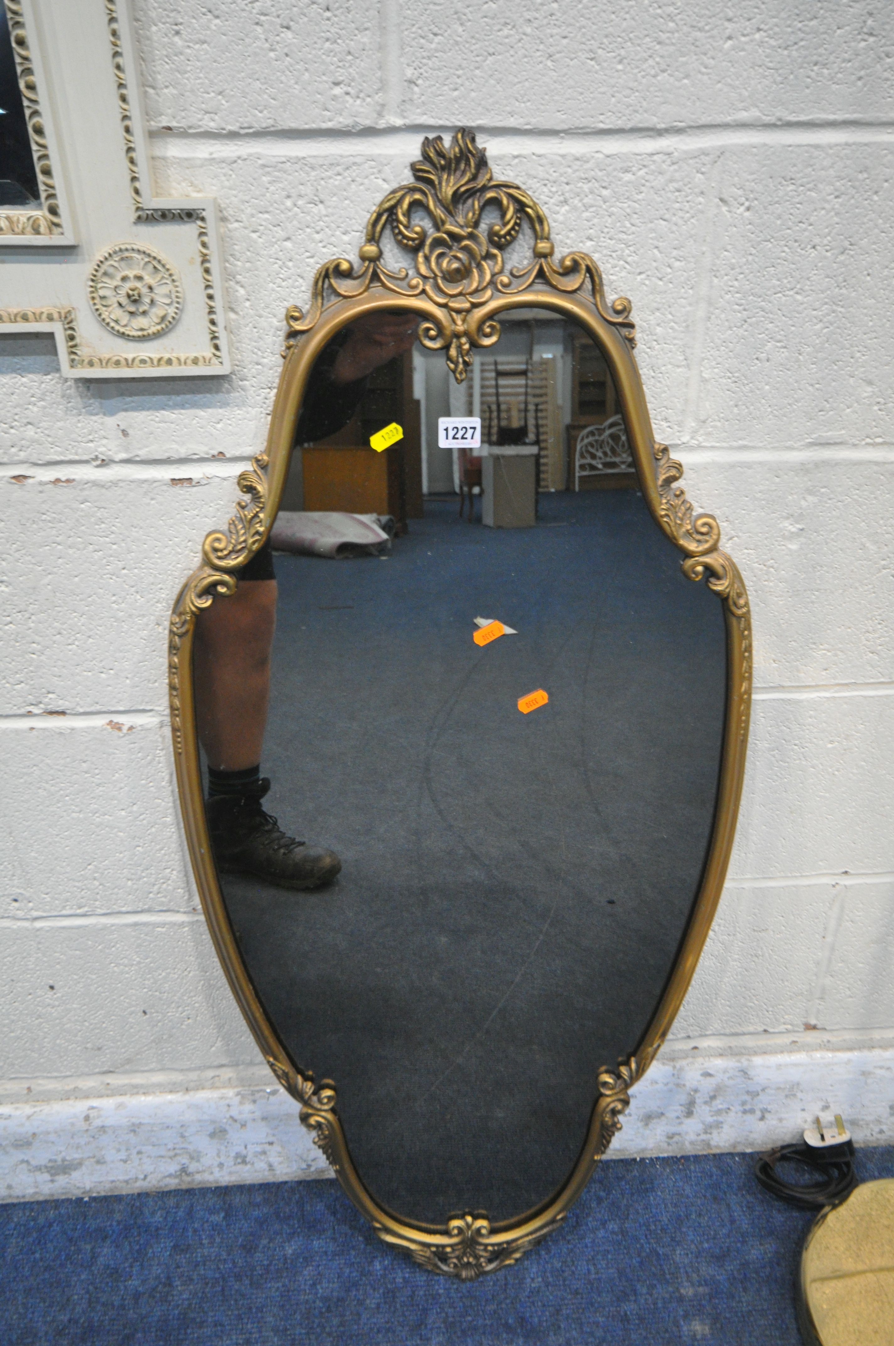 A GILT METAL FRAMED WALL MIRROR, with scrolled and foliate details, 50cm x 110cm, a French wall - Image 2 of 5