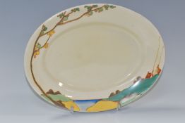 A CLARICE CLIFF OVAL 'SECRETS' PATTERN MEAT PLATE, painted with a stylised tree and cottages in a