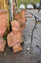 TWO TERRACOTTA COLOURED MODERN COMPOSITE GARDEN FIGURES in the form of a bust of a Grecian lady 64cm