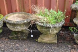 A PAIR OF WEATHERED COMPOSITE CIRCULAR GARDEN PLANTERS with foliate detail and a square foot 49cm in