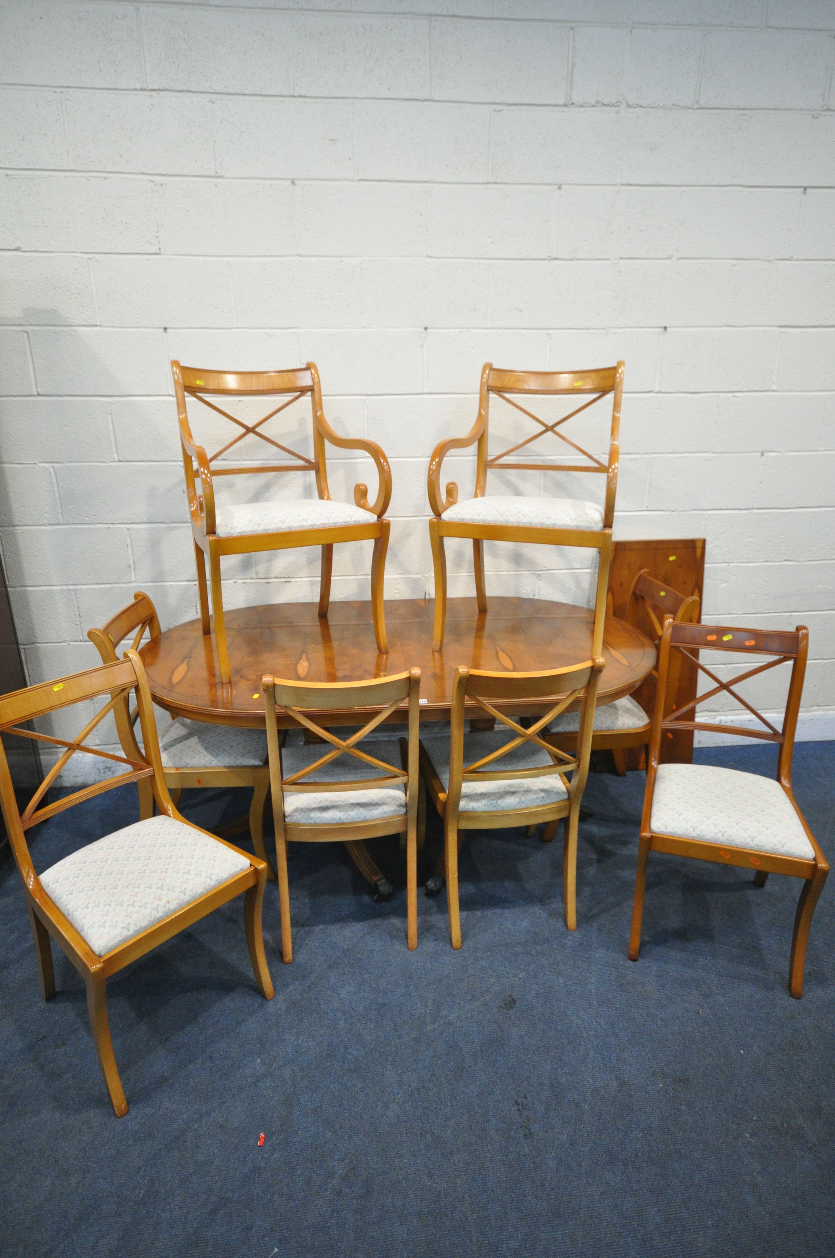 A 20TH CENTURY YEW WOOD TEN PIECE SUITE, comprising an oval twin pedestal dining table, with one