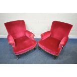 A PAIR OF EARLY 20TH CENTURY ARMCHAIRS, with maroon upholstery, on turned front legs and brass