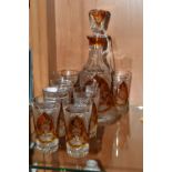 A CONTINENTAL AMBER CUT TO CLEAR DECANTER AND GLASSES, the part set incudes mallet form decanter