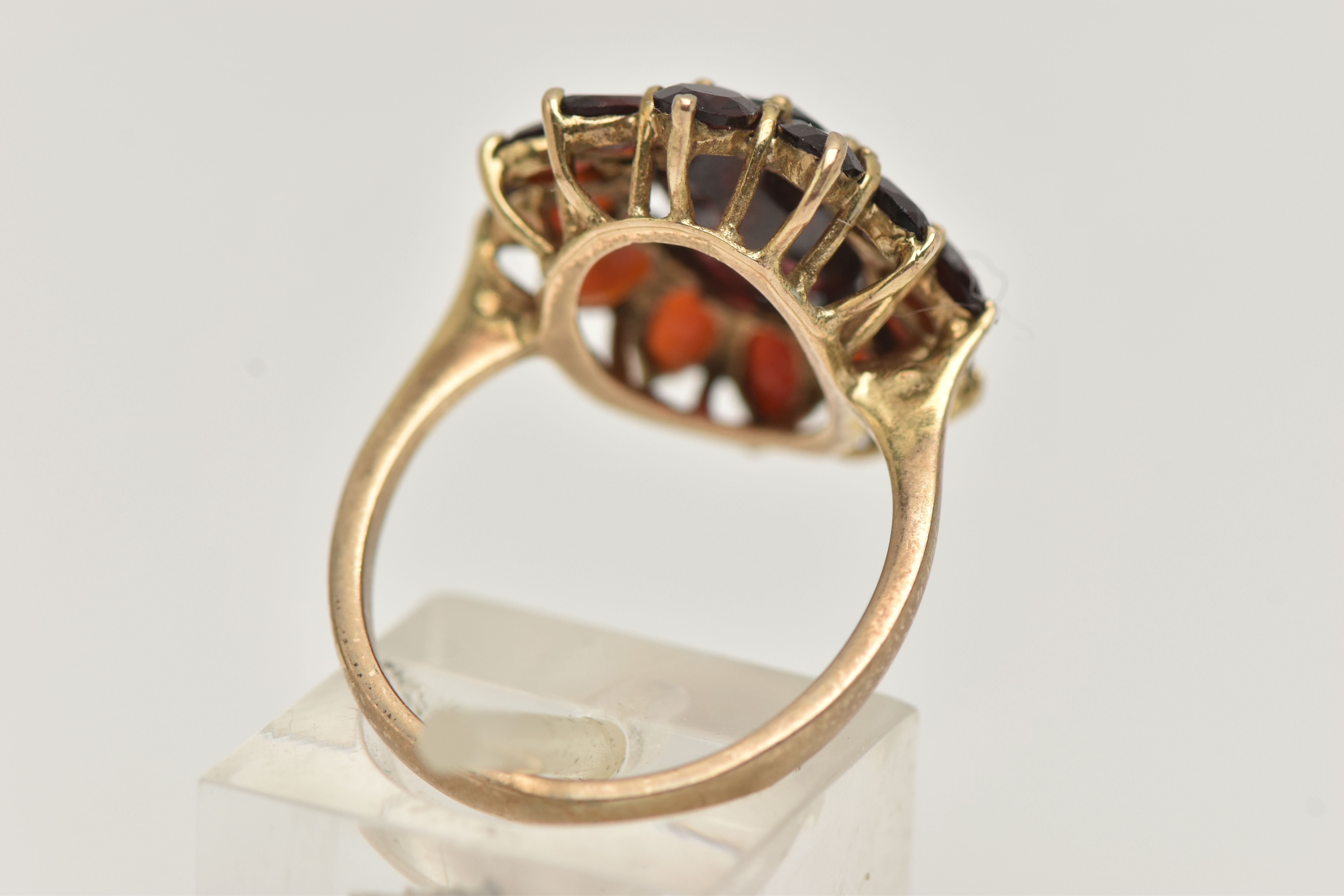 A GARNET CLUSTER RING, designed as a central oval garnet within an oval garnet surround, in claw - Image 3 of 4