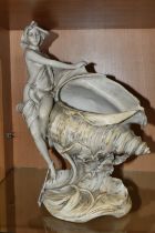 A ROYAL DUX LADY SEATED ON A SHELL FIGURINE, matt white glaze, model 1383, with applied pink Royal