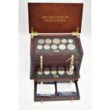 A SMALL WOODEN COIN CABINET, consisting of eight drawers seven containing UK coinage from 1939-1945,