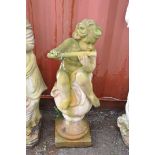 A WEATHERED COMPOSITE GARDEN FIGURE depicting a small child sat on an orbed post finial and