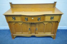 AN ARTS AND CRAFTS GOLDEN OAK BOWFRONT SIDEBOARD, with a raised back, fitted with three drawers,