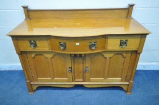 AN ARTS AND CRAFTS GOLDEN OAK BOWFRONT SIDEBOARD, with a raised back, fitted with three drawers,