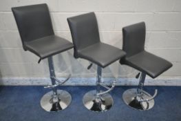 A SET OF THREE HEIGHT ADJUSTABLE BAR STOOLS, with charcoal grey leather upholstery, maximum height