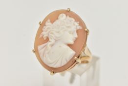 A YELLOW METAL CAMEO RING, the oval cameo in a six claw setting, depicting a lady in profile, to the