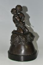 A BRONZE FIGURE GROUP, depicting a mother and child kneeling on top of a mythical beast, loose on