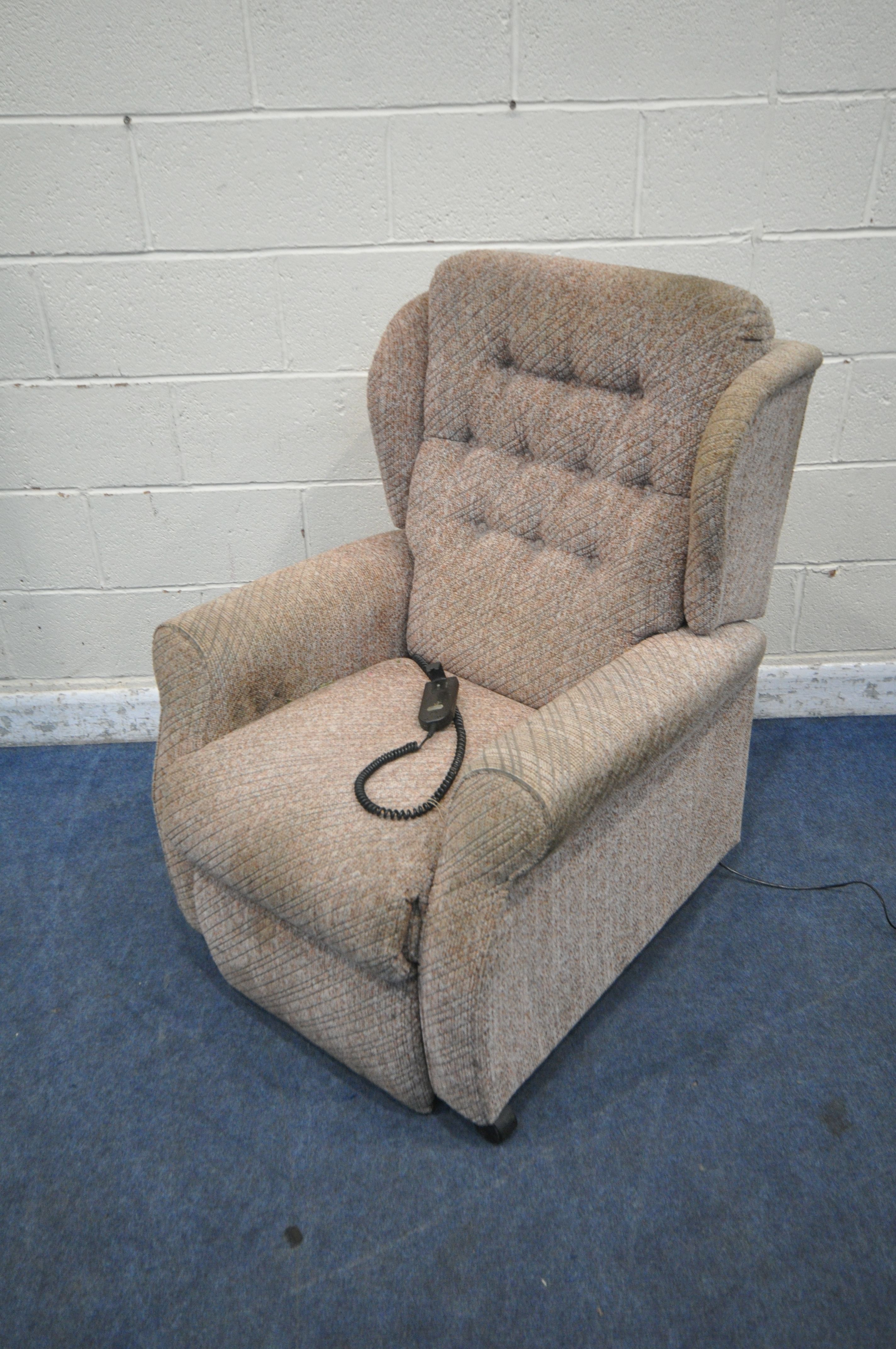 AN UNBRANDED RISE AND RECLINE ARMCHAIR (condition report: in need of a clean, stained,