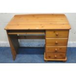 A MODERN PINE DESK, fitted with four drawers and a pull out keyboard tray, width 109cm x depth