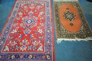 A WOOLLEN RED GROUND IRANIAN RECTANGULAR RUG, with central medallion, foliate design and multi-strap