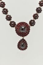 A LATE 19TH CENTURY GARNET NECKLACE, the silver gilt necklace designed as a central circular