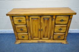 A GOOD QUALITY HEAVY SOLID OAK SIDEBOARD, fitted with two banks of three drawers, flanking double