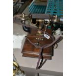 AN EARLY 20TH CENTURY 'THE MAGNET' TELEPHONE, on a wooden base, height 20cm (Condition Report: in