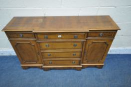 A 20TH CENTURY YEW WOOD BREAKFRONT SIDEBOARD, fitted with three drawers, above three cupboard