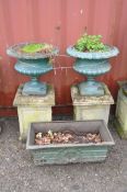 A PAIR OF EARLY 20TH CENTURY CAST IRON PAINTED URNS ON COMPOSITE SQUARE STANDS the urns are baluster