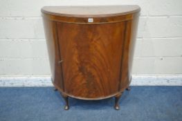 A 20TH CENTURY FLAME MAHOGANY DEMI-LUNE CABINET, with a single door, that's enclosing three shelves,
