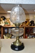 AN ART NOUVEAU OIL LAMP AND SHADE, complete with chimney, approximate height excluding shade 35cm,
