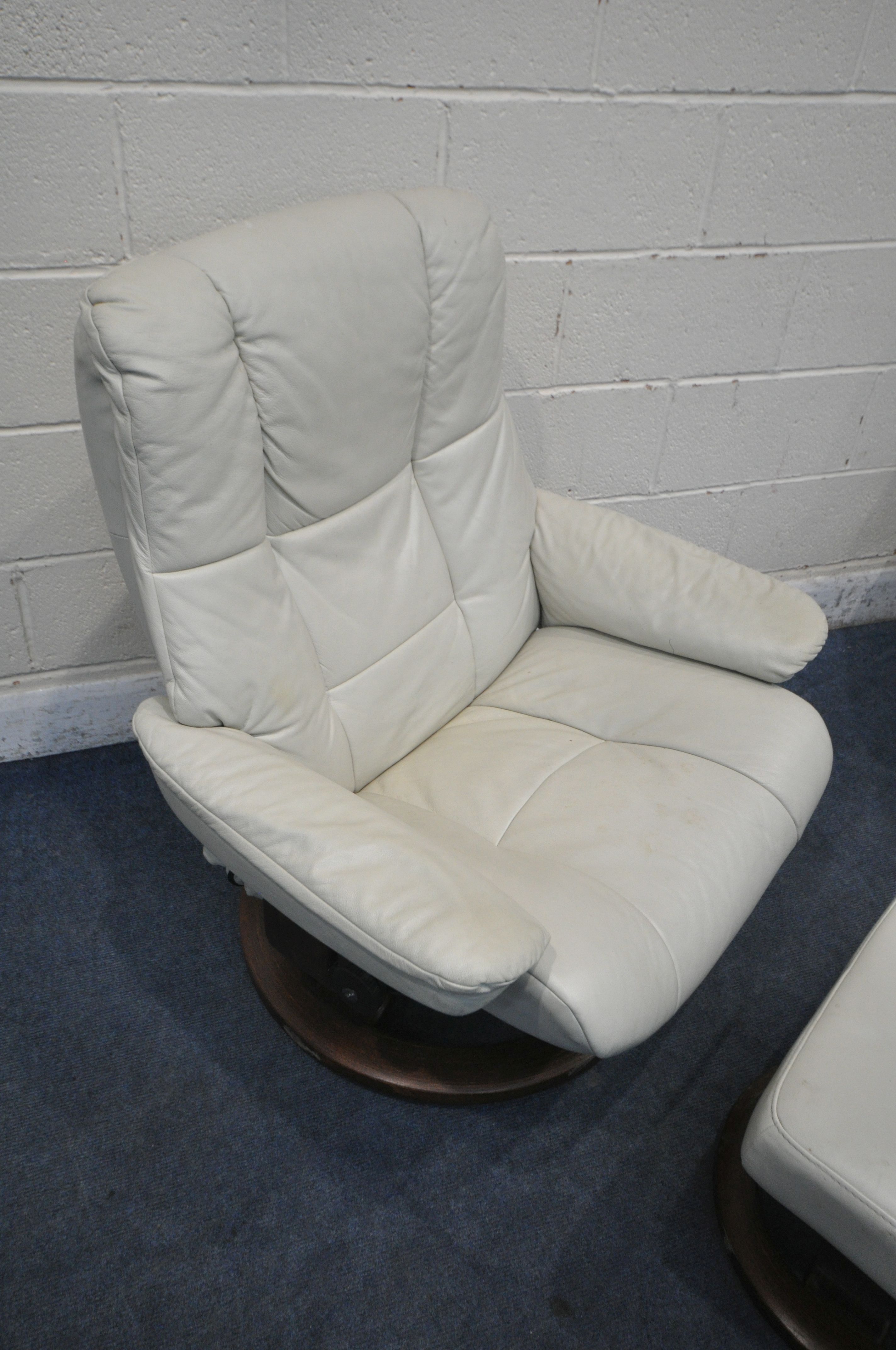 TWO SIZED EKORNES STRESSLESS CREAM LEATHER ARMCHAIRS, along with a pair of footstools (condition - Image 2 of 6