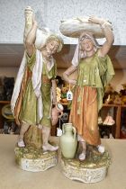 ROYAL DUX, TWO PORCELAIN SCULPTURES OF FIGURES CARRYING PROVISIONS, female has a pink DPM mark to