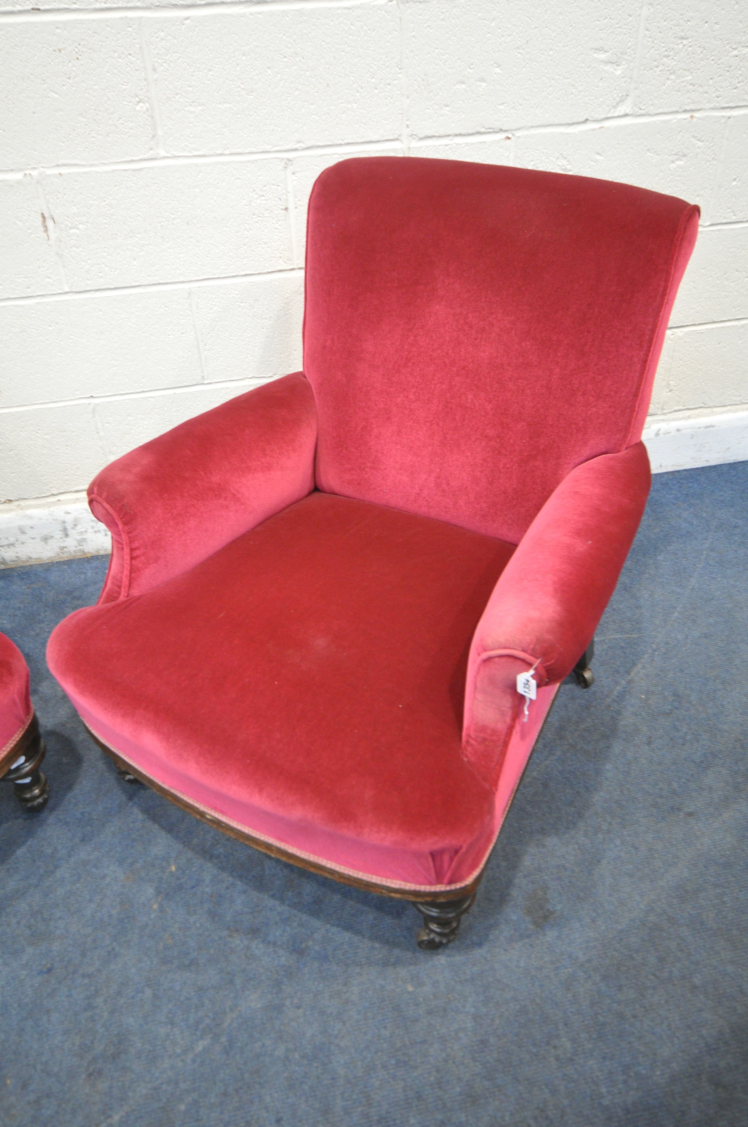 A PAIR OF EARLY 20TH CENTURY ARMCHAIRS, with maroon upholstery, on turned front legs and brass - Image 2 of 4