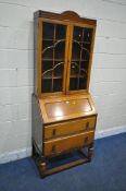 A 20TH CENTURY OAK BUREAU BOOKCASE, fitted with double glazed doors, that are enclosing three