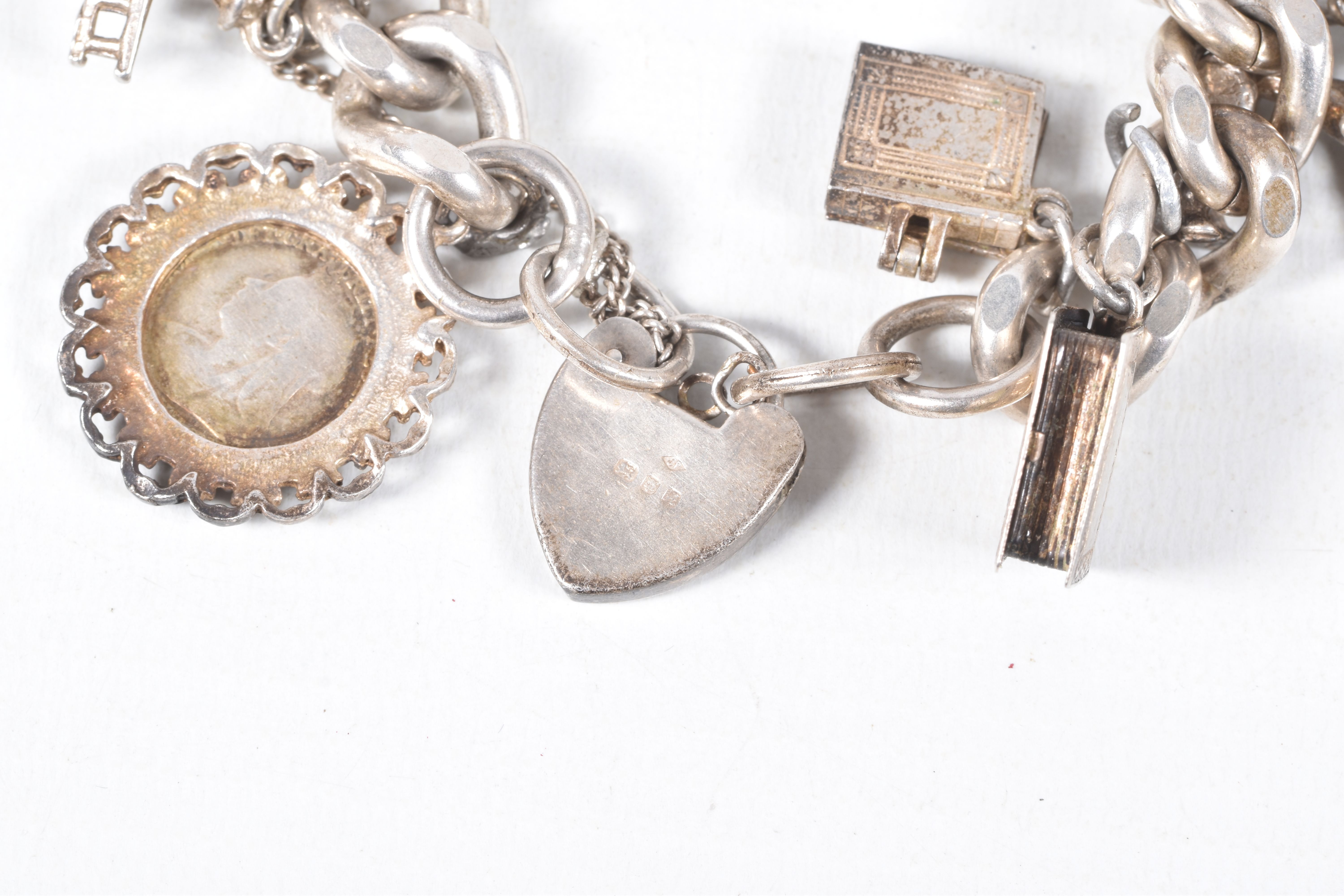 A SILVER CHARM BRACELET, a heavy curb link bracelet fitted with a heart padlock clasp, hallmarked ' - Image 6 of 7