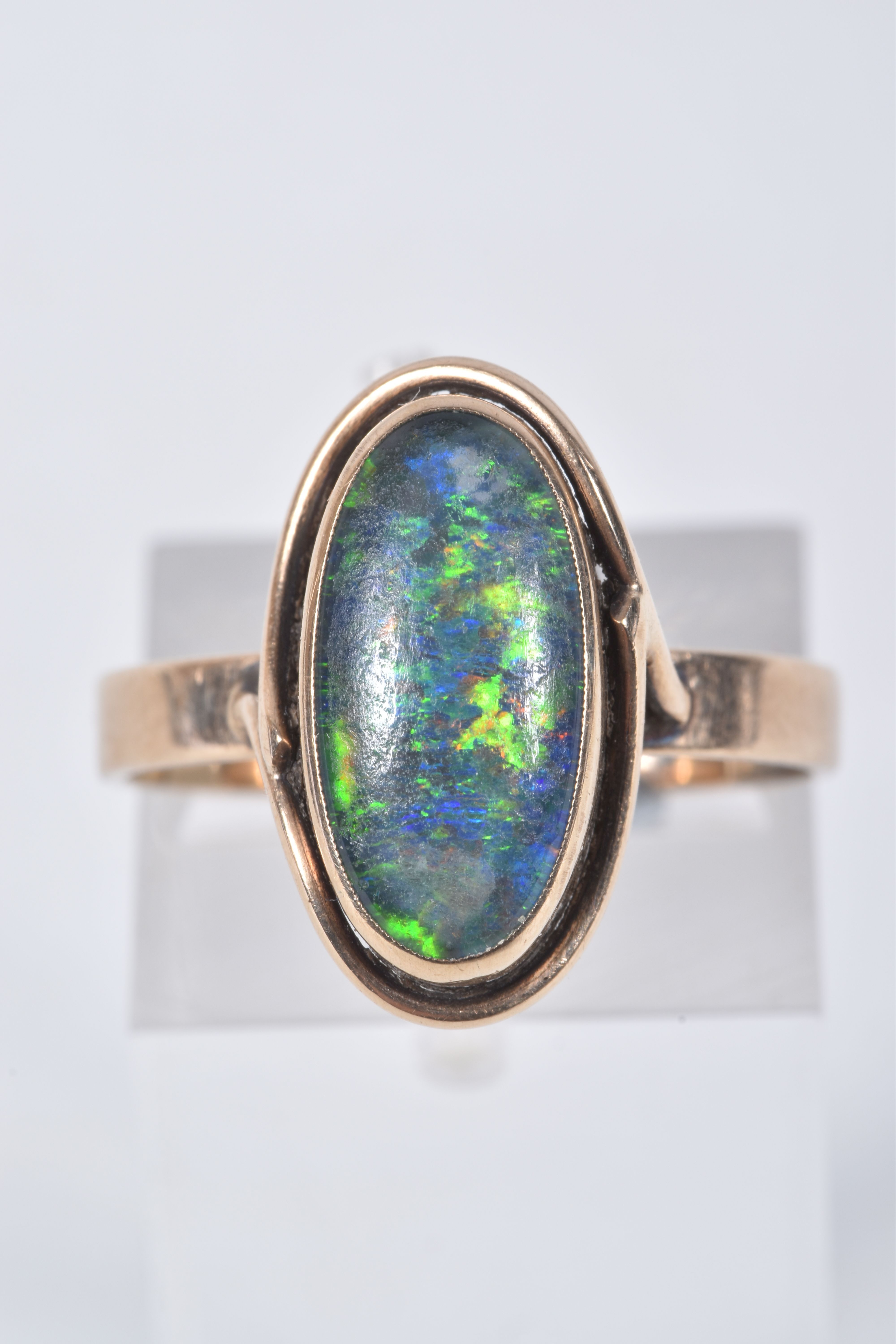 A YELLOW METAL OPAL TRIPLET RING, of an oval design, collet set opal triplet, to a scroll surround - Image 2 of 5