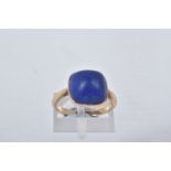 A LAPIS LAZULI RING, designed as a square lapis lazuli cabochon in a collet setting to the plain