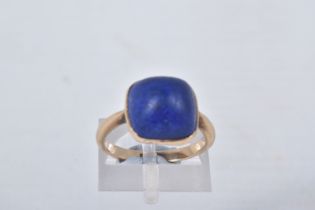 A LAPIS LAZULI RING, designed as a square lapis lazuli cabochon in a collet setting to the plain