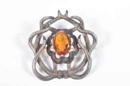 A 19TH CENTURY 'MACKAY' BROOCH, an oval cut Cairngorm, centrally set in a surround of stylised