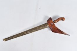 A TWENTIETH CENTURY KRISS DAGGER WITH ORNATE SCABBARD, this features a carved wooden pommel and an