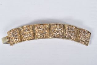 A VICTORIAN GILT BRACELET, comprised of six slightly tapered panels, embossed with an Indian design,