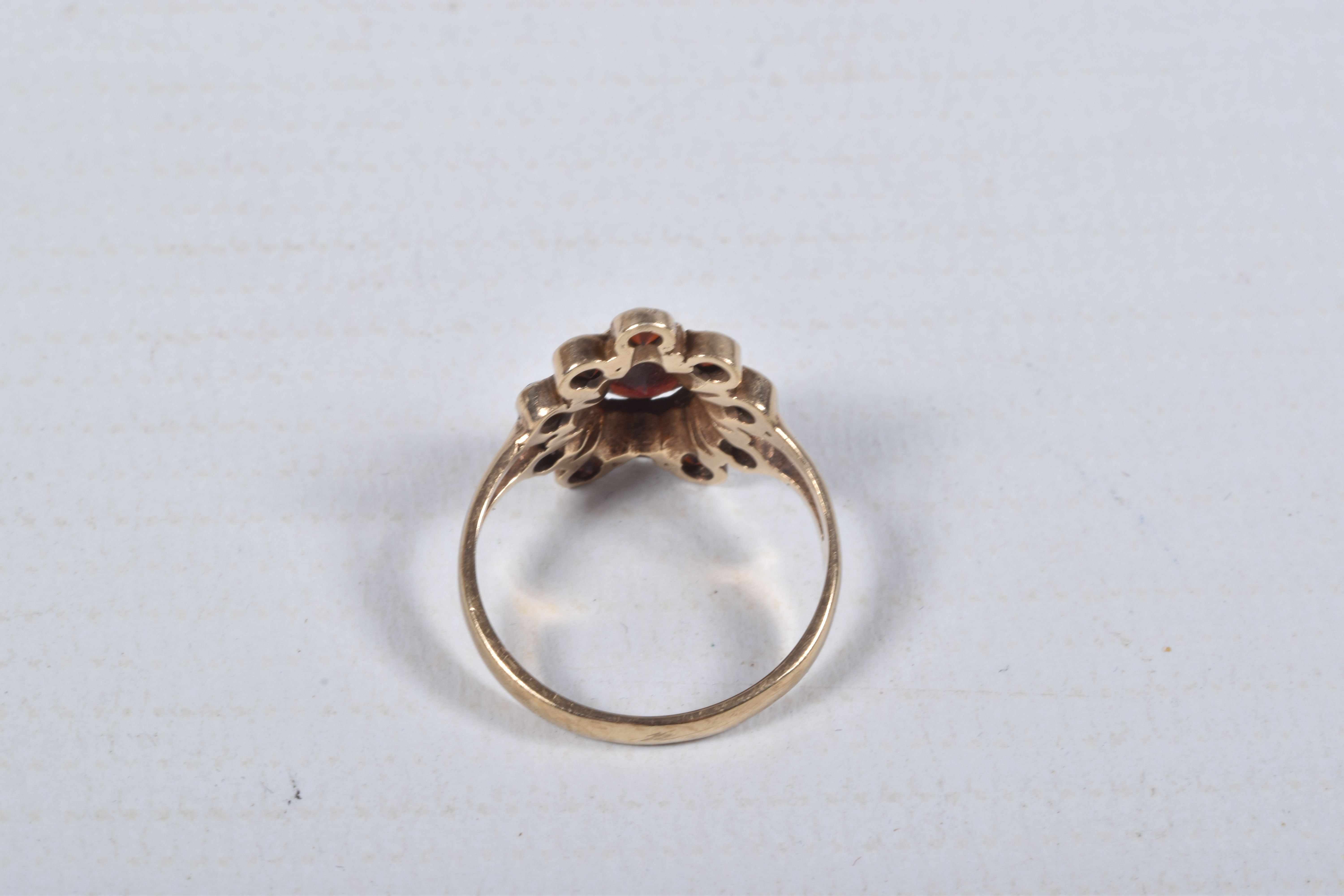 A 9CT GOLD GARNET CLUSTER RING, designed as a central pear shape garnet within a circular cut garnet - Image 3 of 4