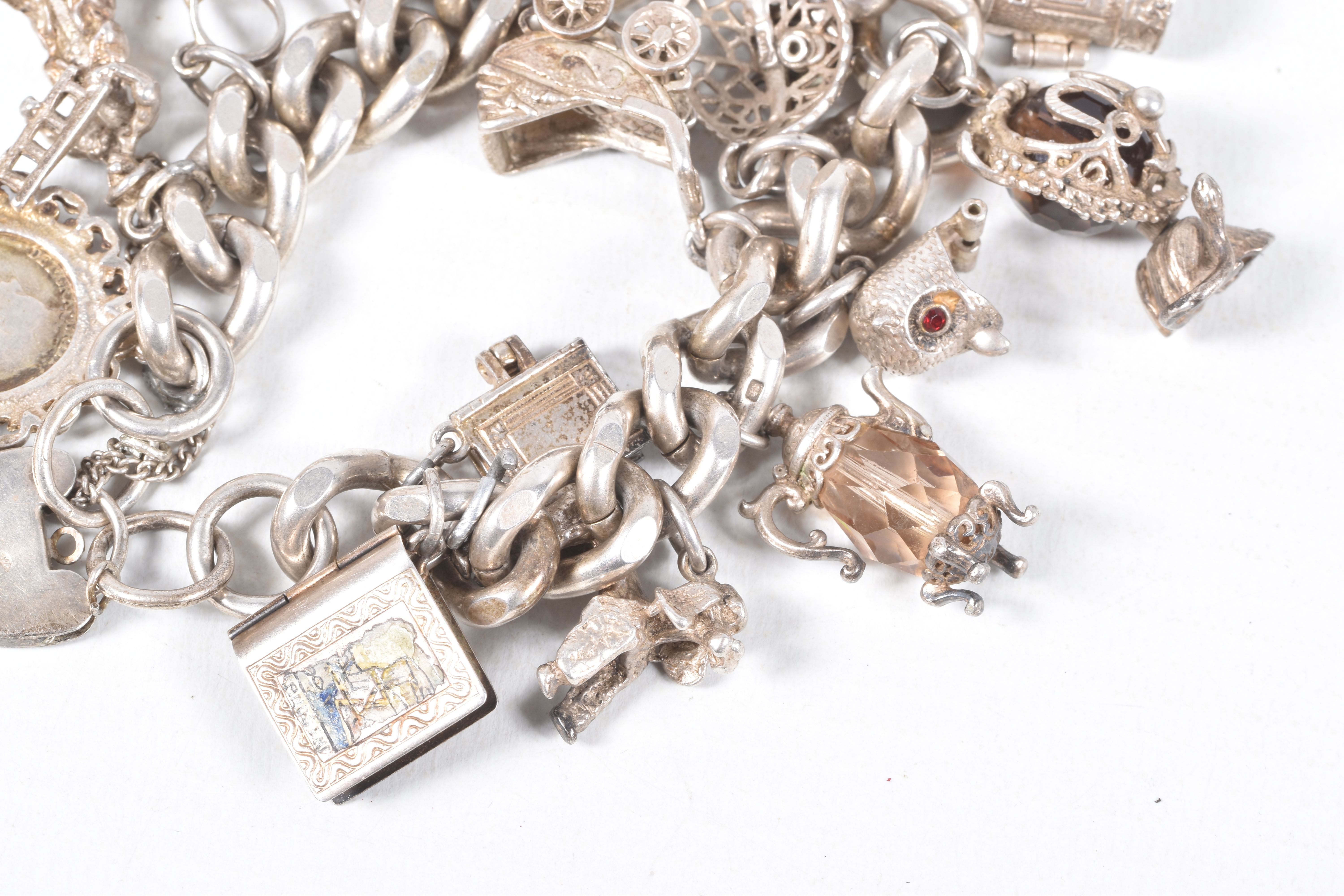 A SILVER CHARM BRACELET, a heavy curb link bracelet fitted with a heart padlock clasp, hallmarked ' - Image 5 of 7