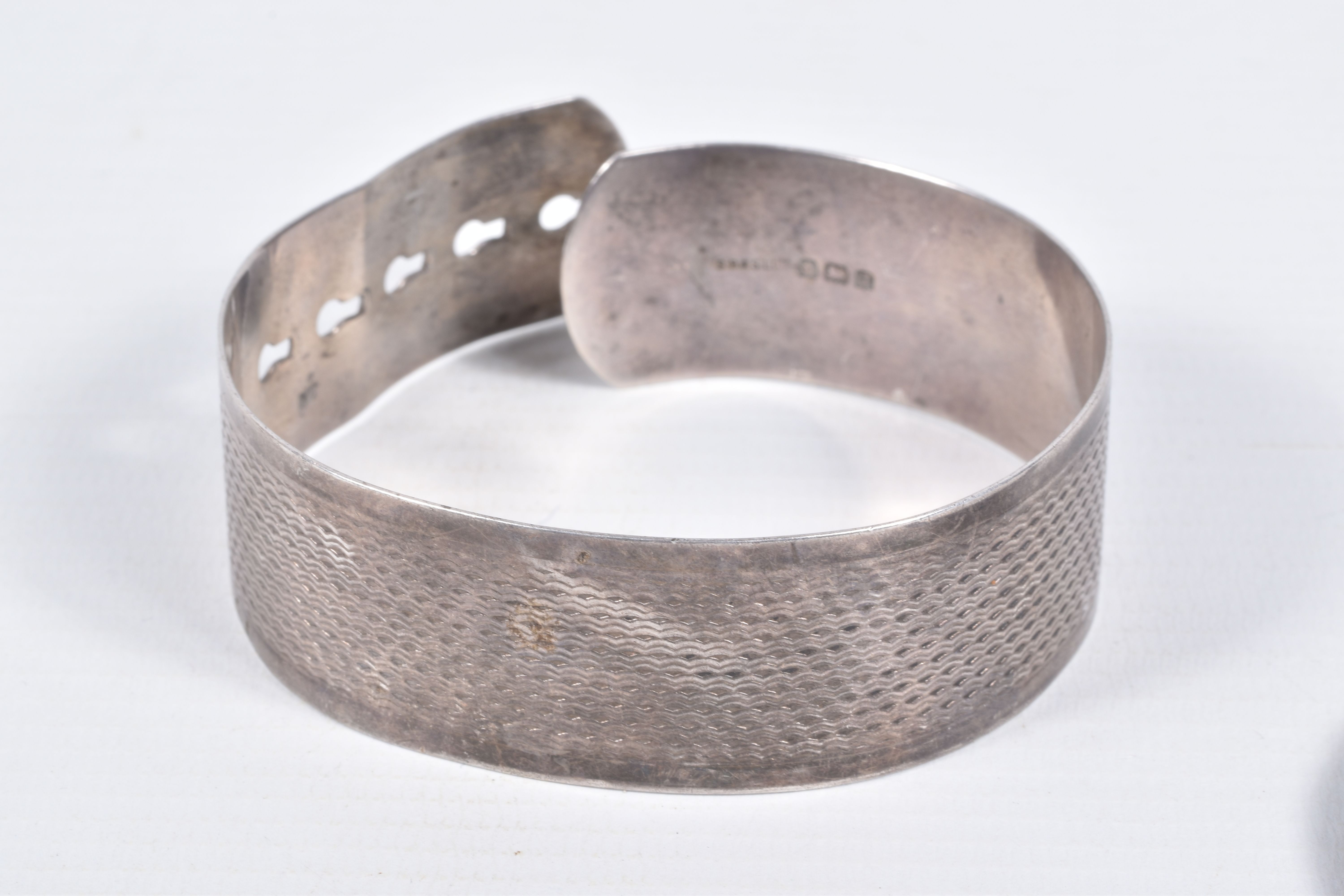FOUR ITEMS OF JEWELLERY, to include a silver wide engine turned pattern belt designed bangle, - Image 6 of 6