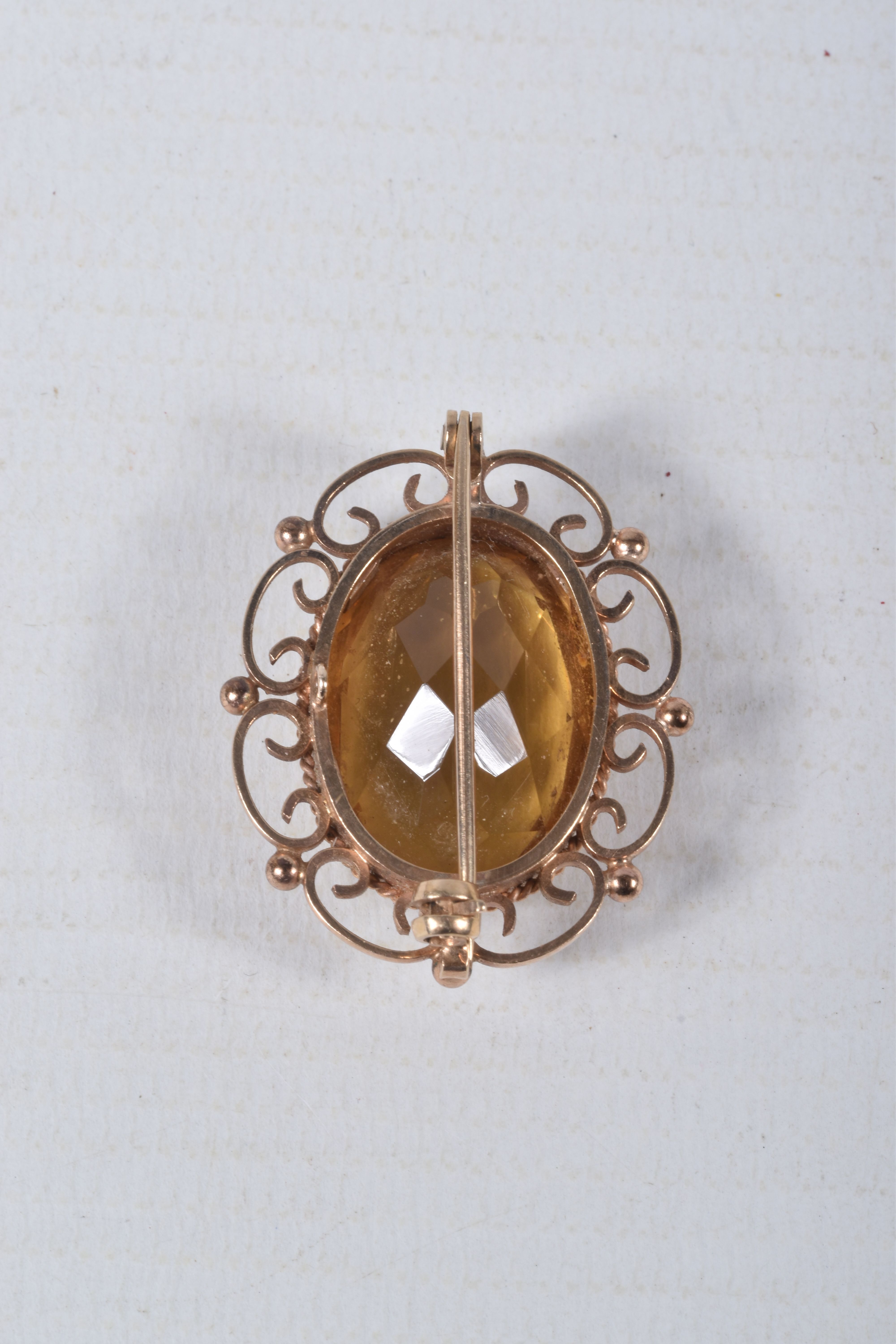 A 9CT GOLD CITRINE BROOCH, of an oval form, set with a large oval cut citrine, in a milgrain - Image 2 of 3