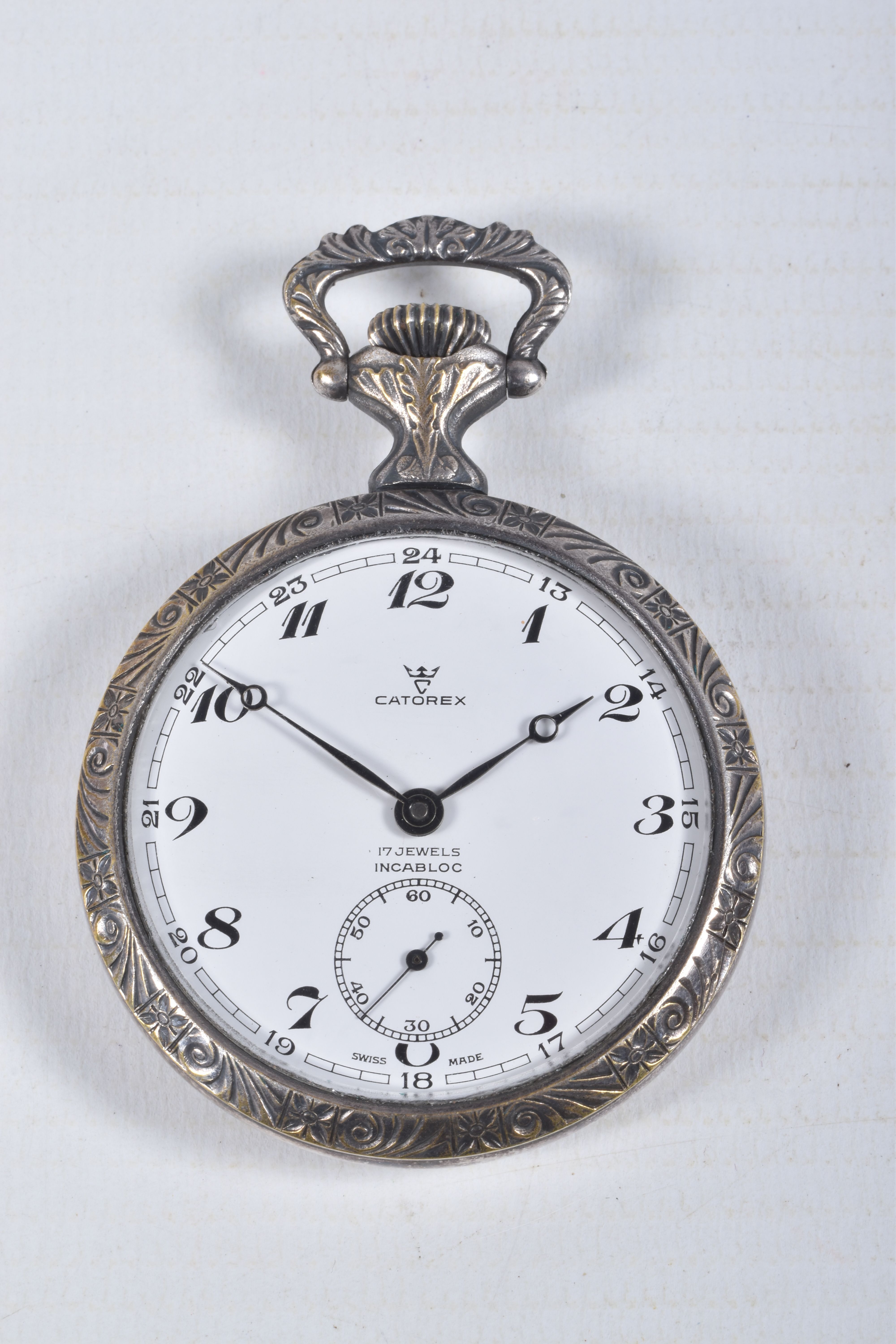 A WHITE METAL 'CATOREX' OPEN FACE POCKET WATCH, manual wind, round white dial signed 'Catorex',