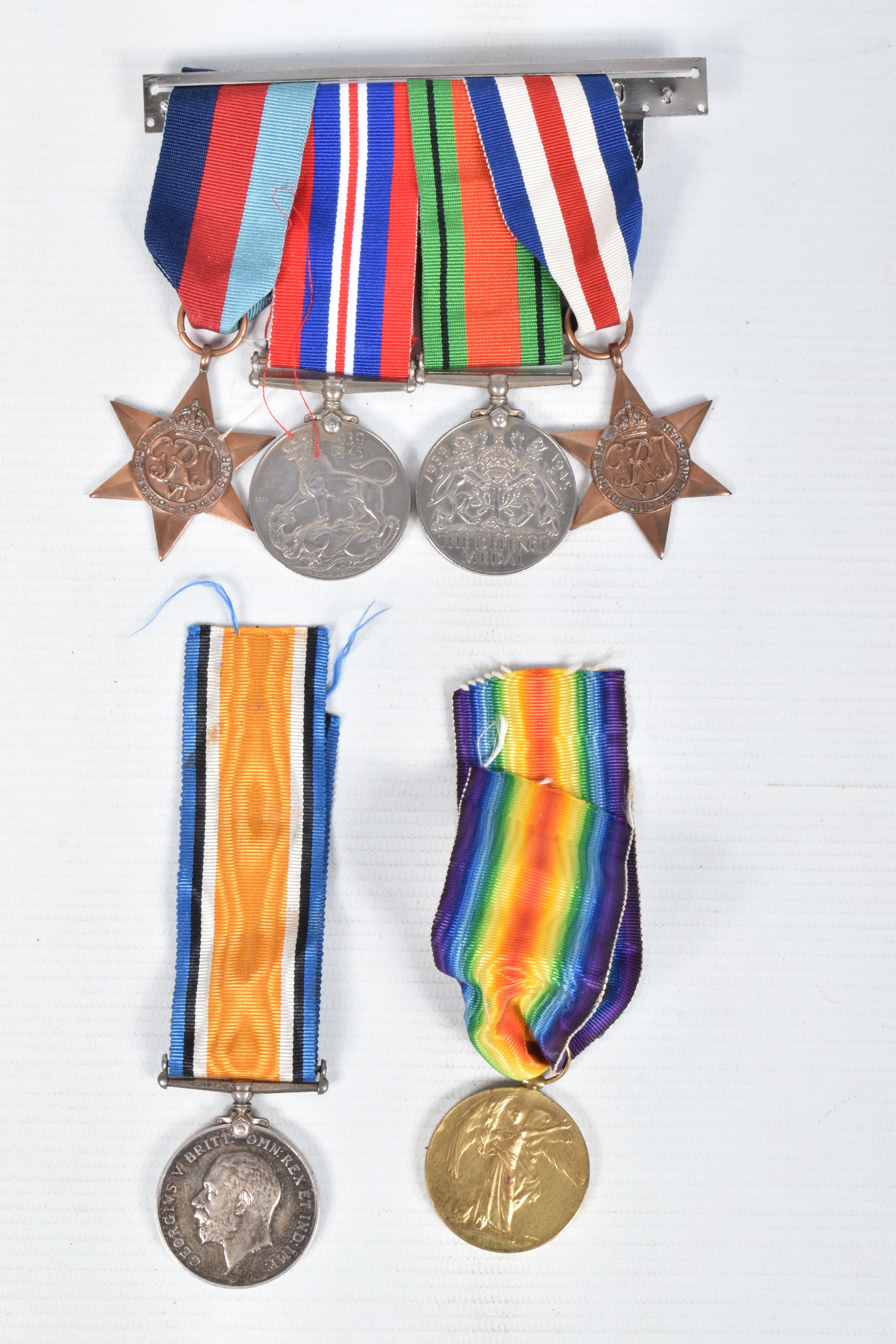 A PAIR OF WWI MEDALS AND FOUR WWII MEDALS, the WWI medals are correctly named to private 99551 Afred