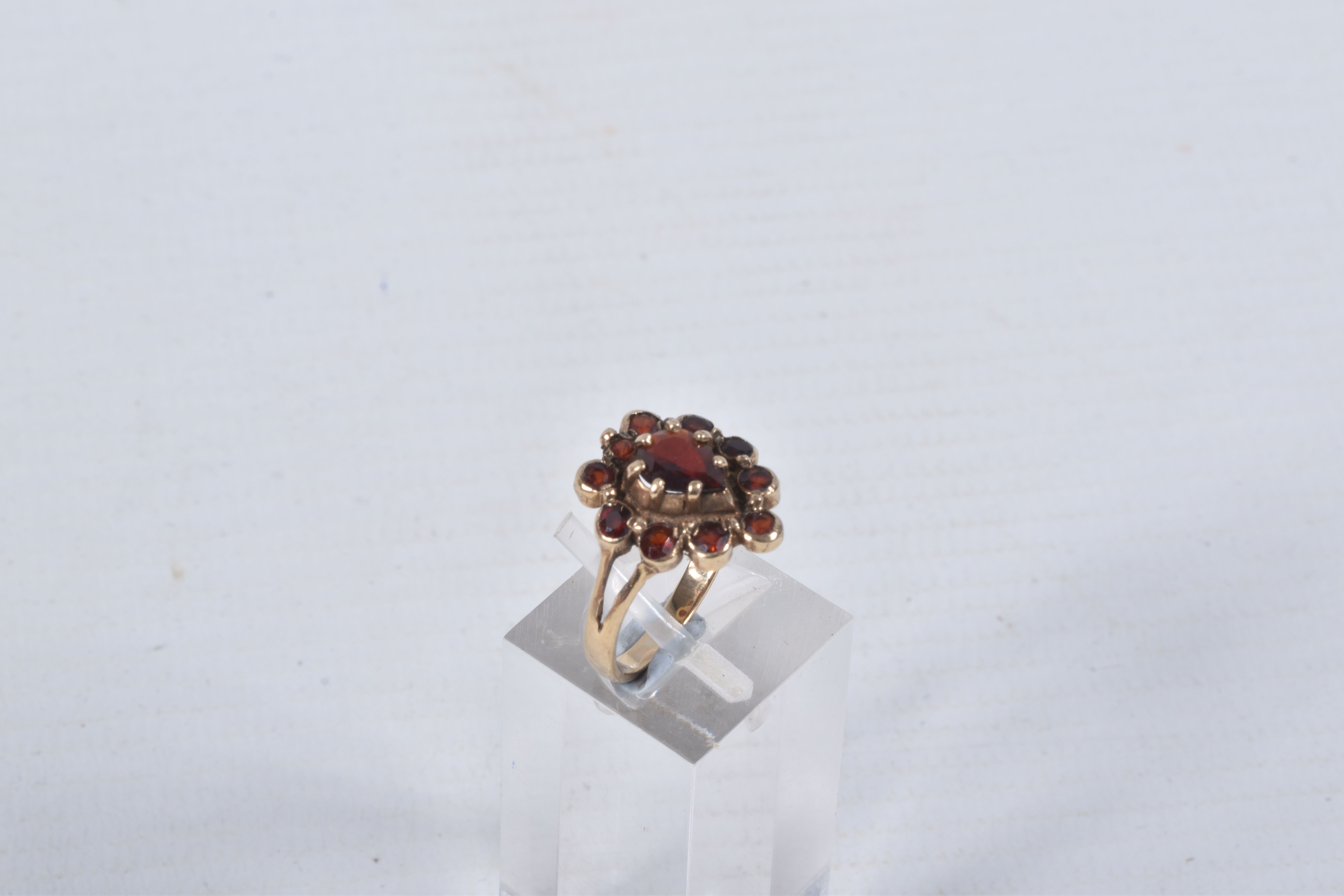 A 9CT GOLD GARNET CLUSTER RING, designed as a central pear shape garnet within a circular cut garnet - Image 2 of 4