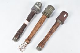 THREE INERT GERMAN STYLE STICK GRENADES, all three have wooden handles, the first has the words