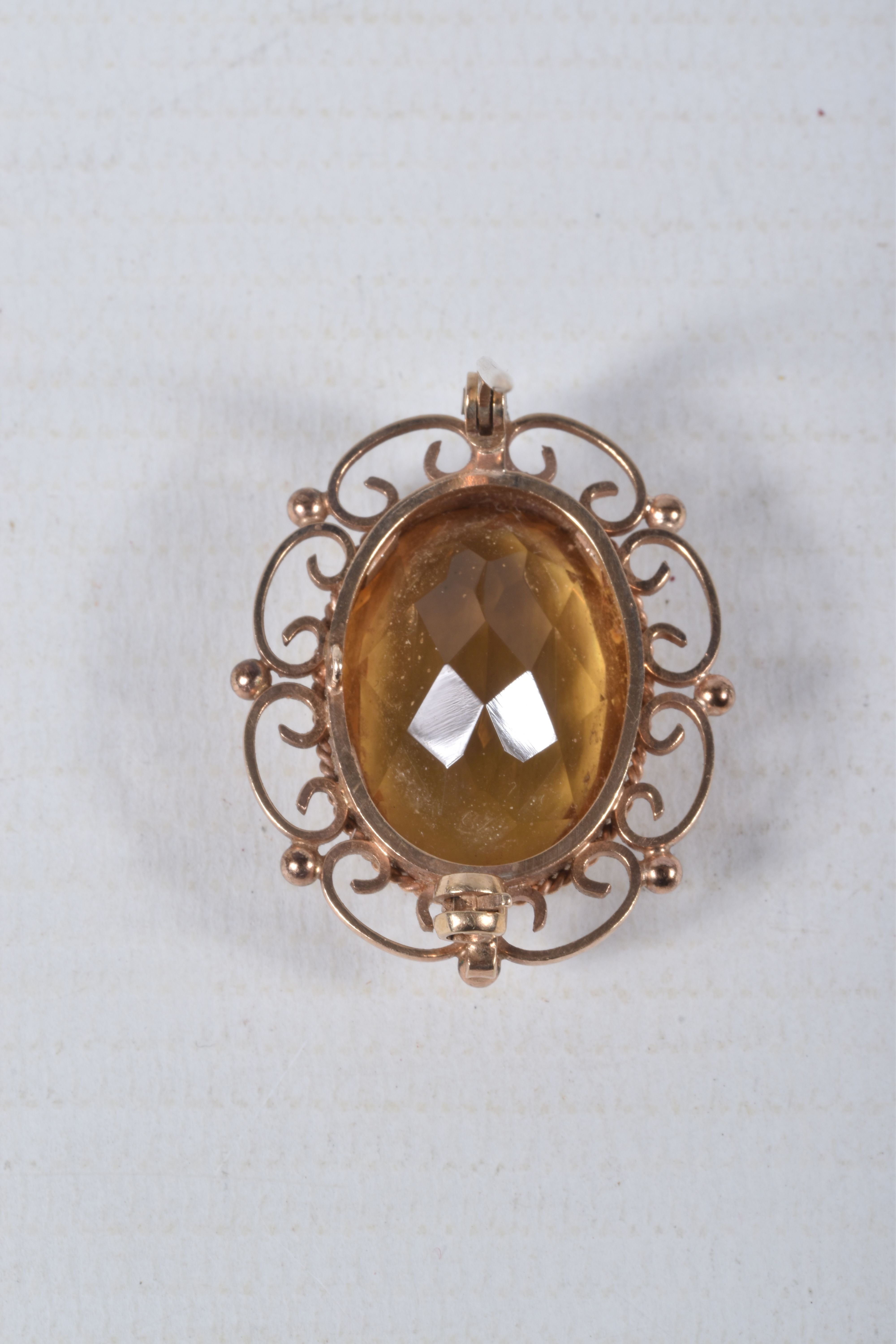 A 9CT GOLD CITRINE BROOCH, of an oval form, set with a large oval cut citrine, in a milgrain - Image 3 of 3