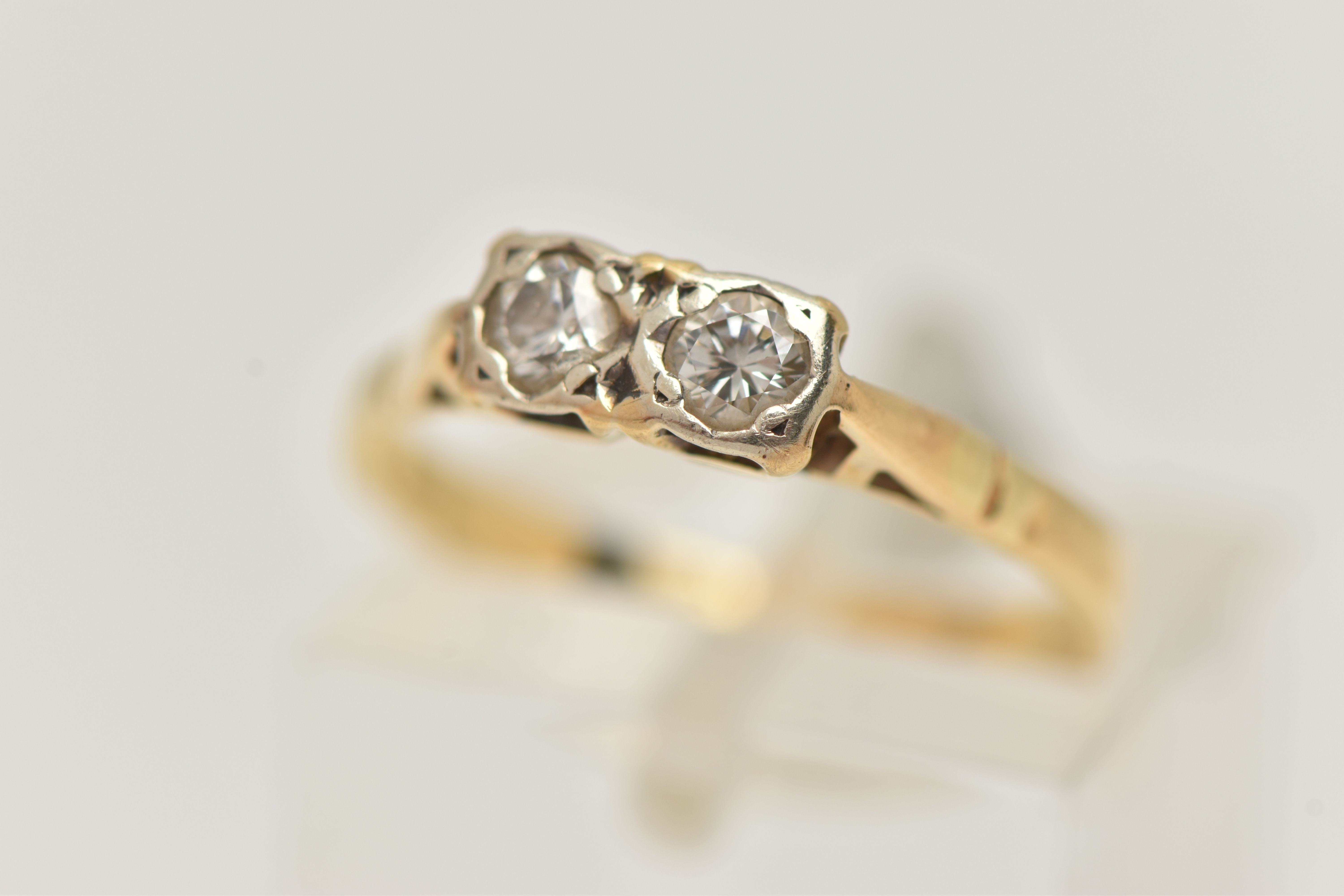 A DIAMOND TWO STONE RING, set with round brilliant cut diamonds, each measuring approximately 3.