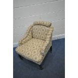 AN EDWARDIAN BEIGE AND FLORAL UPHOLSTERED ARMCHAIR, with sloped armrests, width 67cm x depth 75cm